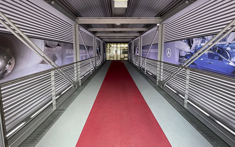 A long hallway with red carpet and a red carpet.